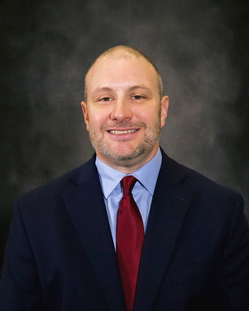 Brian Bibb, man in navy suit with red tie